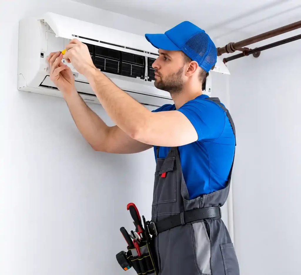 Air Conditioning Repair in Bahrain technician servicing indoor AC unit.