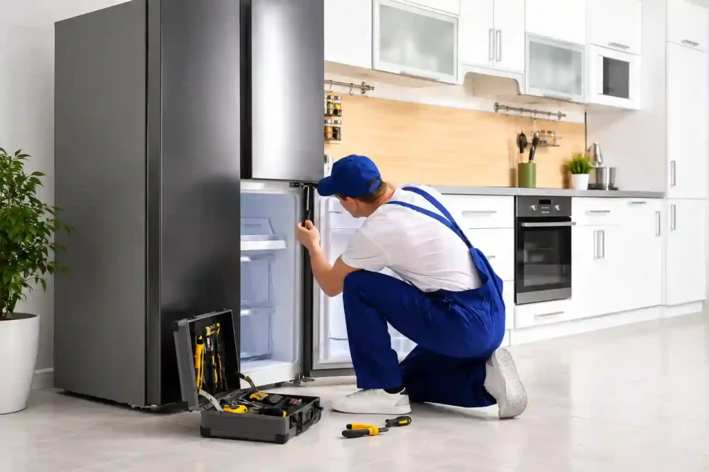 Refrigerator Repair in Hamad Town technician servicing refrigerator.