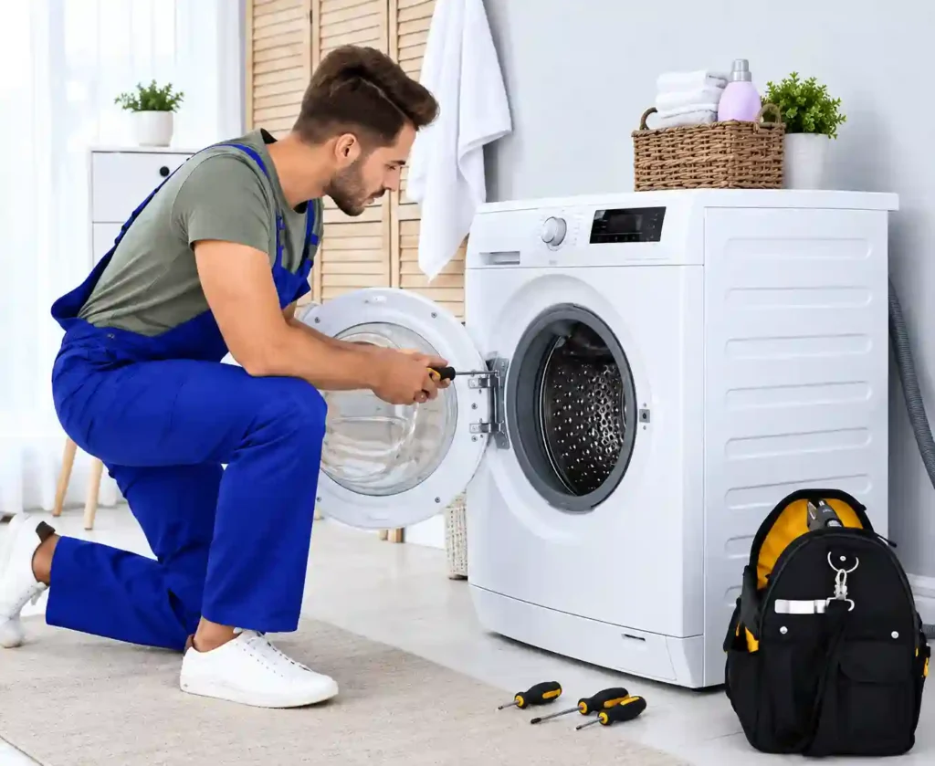 Technician repairing a washing machine for appliance repair in Bahrain.