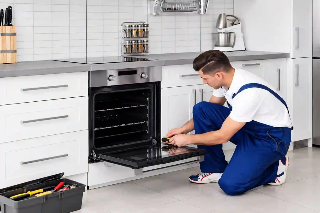 Technician servicing a built-in kitchen oven.
